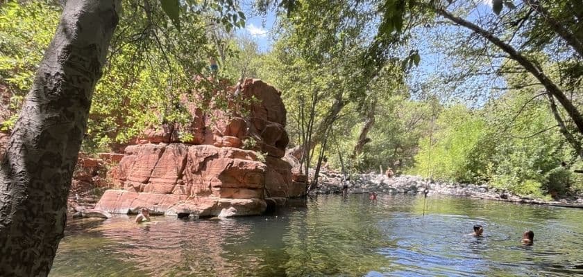 Bull Pen swimming hole in Sedona, surrounded by trees and clear water.