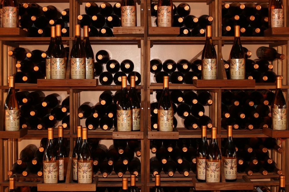 One of the best ways to explore Arizona's amazing wineries is with Sip Sedona Wine Tours. Better yet, they offer door-to-door service! Wall of wine bottles 